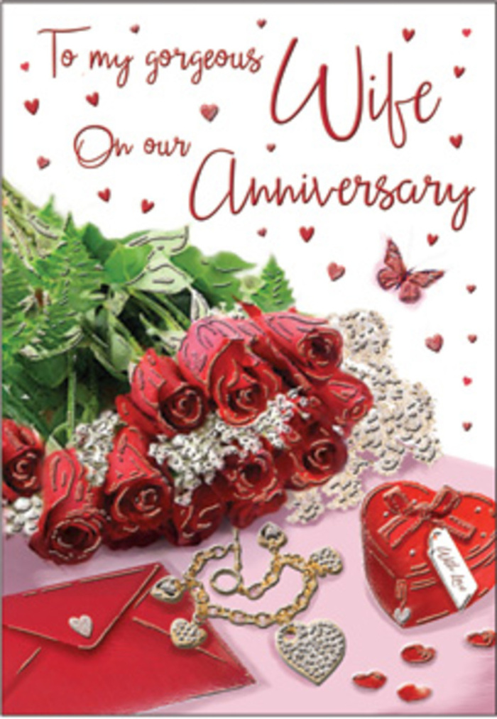 In this evocative anniversary image, the composition is arranged with the calm poise of a still life set in a Hampstead Garden Suburb sitting room, where gentle daylight filters in and softens every edge. A bouquet of classic red roses, not formally bound but gathered in an intimate cluster, lies gracefully across the scene. Each rose is fully open, its deep red petals spiralling toward the centre, rich and velvety, almost glowing against the background. Lush greenery twists between the blooms, adding texture and a touch of woodland freshness reminiscent of a shaded walk through nearby Lyttelton Playing Fields. To one side rests an elegant envelope, its crisp fold hinting at an affectionate message tucked inside, while close by a piece of jewellery - perhaps a delicate necklace or bracelet - glints quietly, its polished surface catching the light in slender flashes. A small, heart-shaped keepsake box in striking red anchors the composition, suggesting treasured memories stored over years of shared anniversaries. Scattered across the surrounding space are tiny heart motifs and sparkling decorative accents, like confetti from a private celebration. A single butterfly ornament appears within the design, a subtle emblem of renewal and the evolving nature of love. The colour palette leans into passionate reds, warm creams, and soft blush tones, all bathed in a gentle glow that makes the textures of metal, card, and petals feel almost touchable. There is a sense of pause and reflection in the arrangement, an atmosphere of quiet romance well suited to an anniversary card chosen by couples in Hampstead Garden Suburb who want their sentiments delivered with understated elegance and heartfelt sincerity.